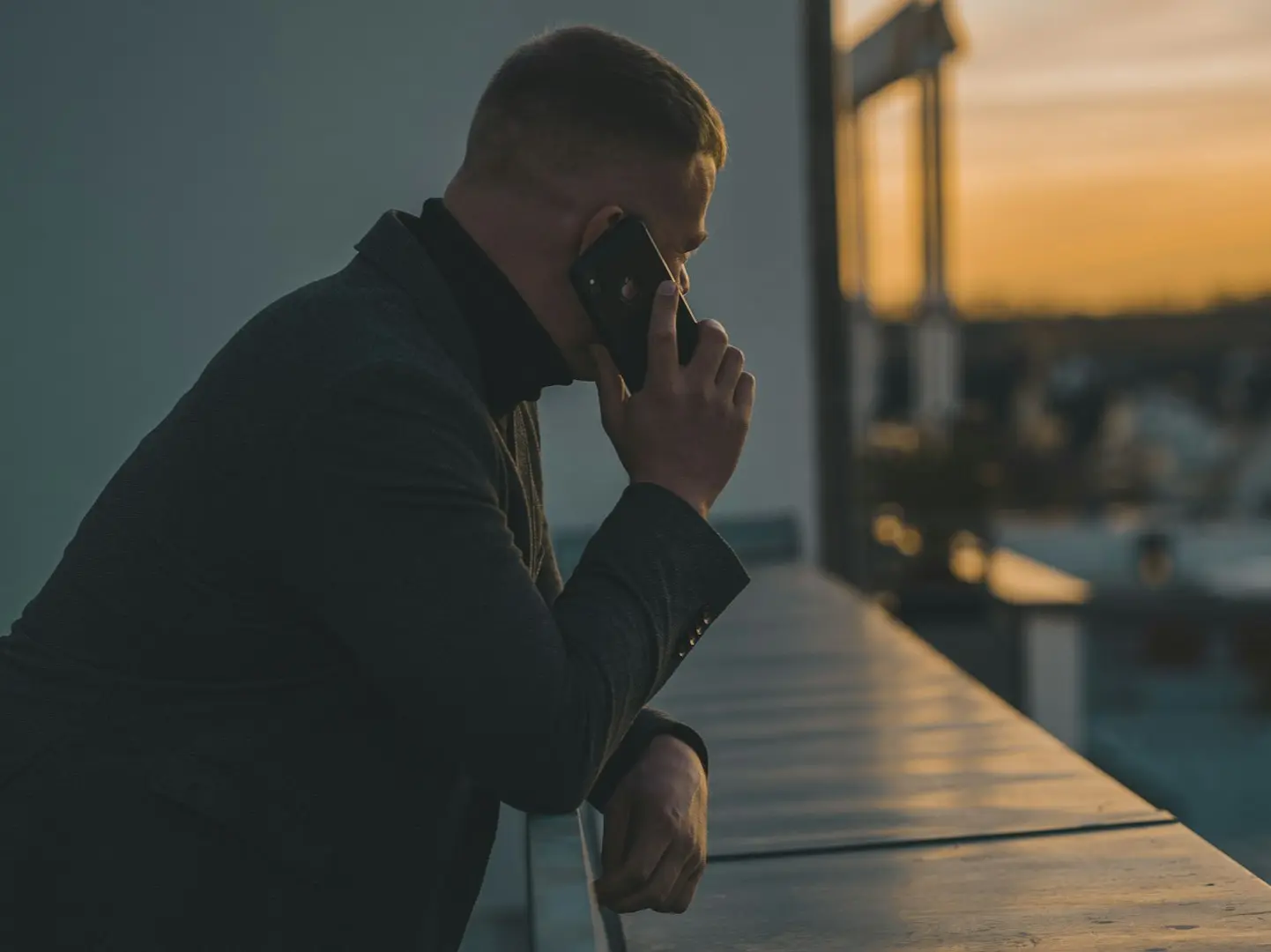 man in black long sleeve shirt sitting by the table